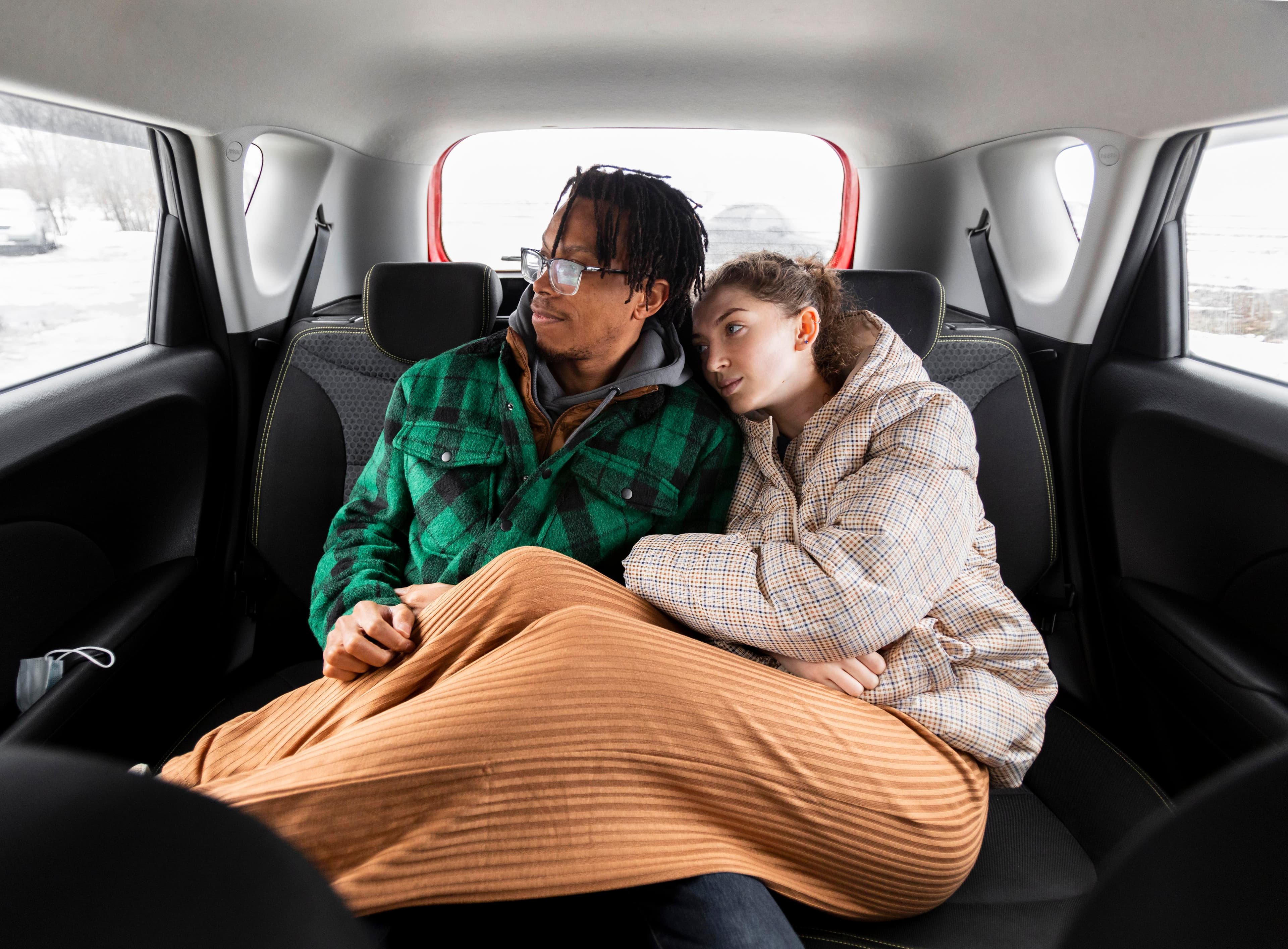 A couple enjoying the ride together in the back seat